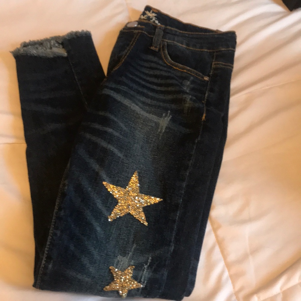 Dark wash skinny jeans with jeweled gold stars